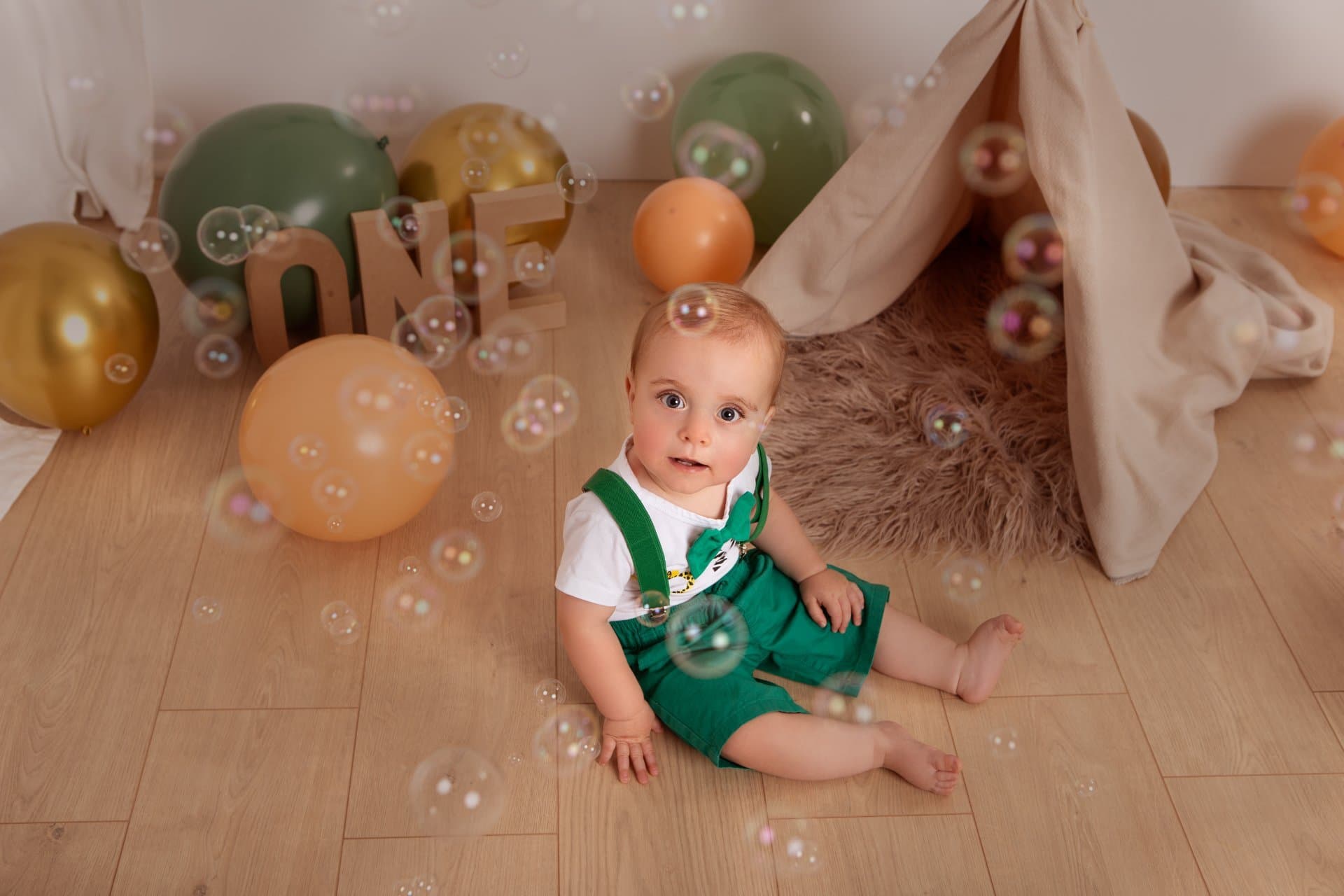 Baby in a clean birthday outfit before the cake smash session